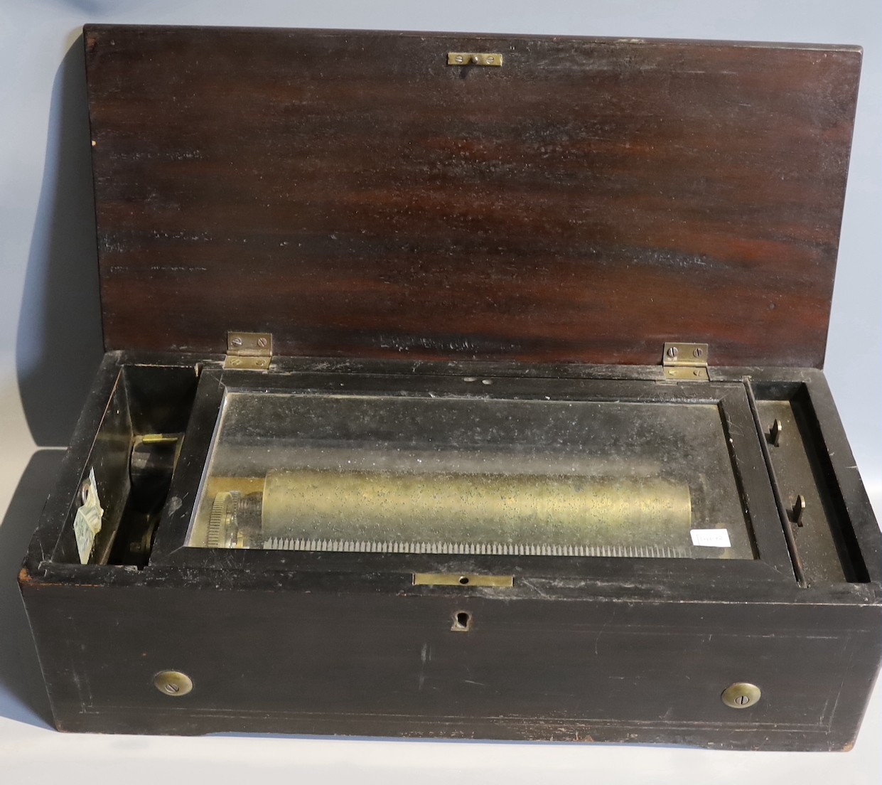 A 19th century and later Swiss music box, with 27cm cylinder, together with a music box case containing a quantity of music and clock parts